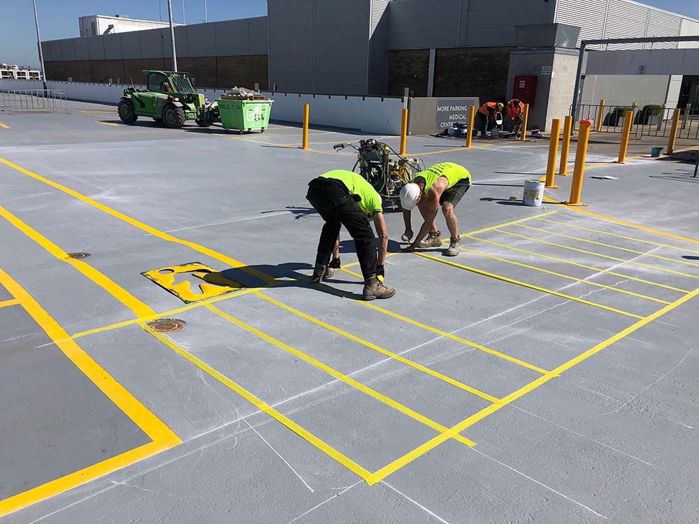 Painting motorcycle parking bays at a shopping centre near Blacktown, Sydney NSW